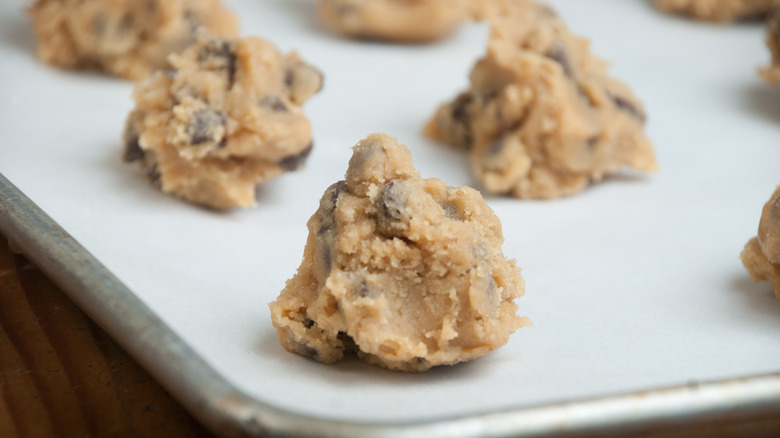 balls of raw cookie dough on baking sheet