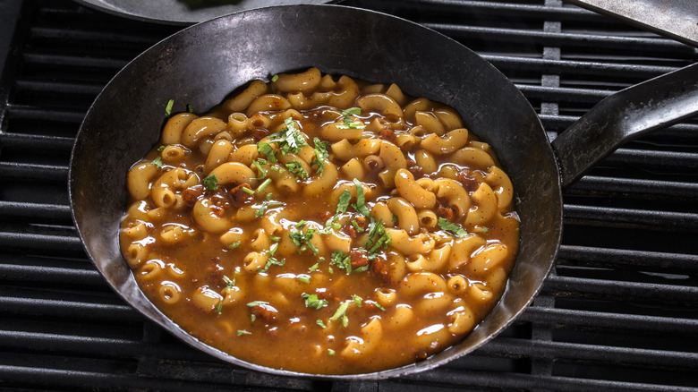 Pan containing beef, pasta, and herbs with sauce