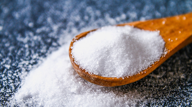 Wooden spoon overflowing with salt