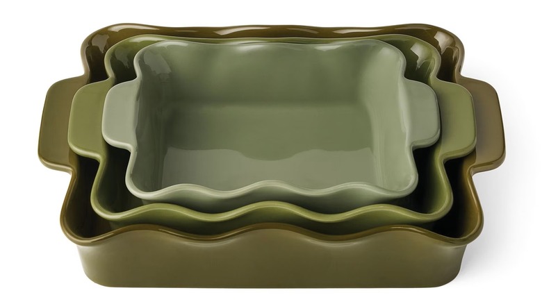 Green bakeware set with wavy edge designs and handles.