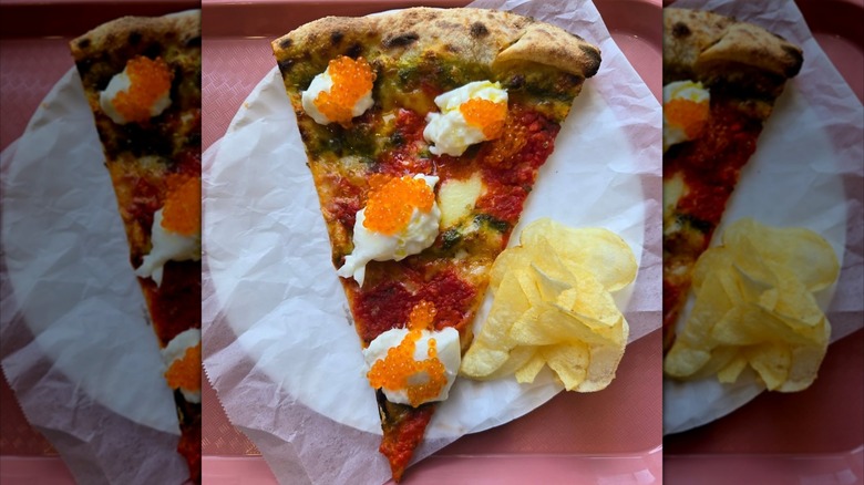 slice of pizza topped with burrata and ikura with potato chips