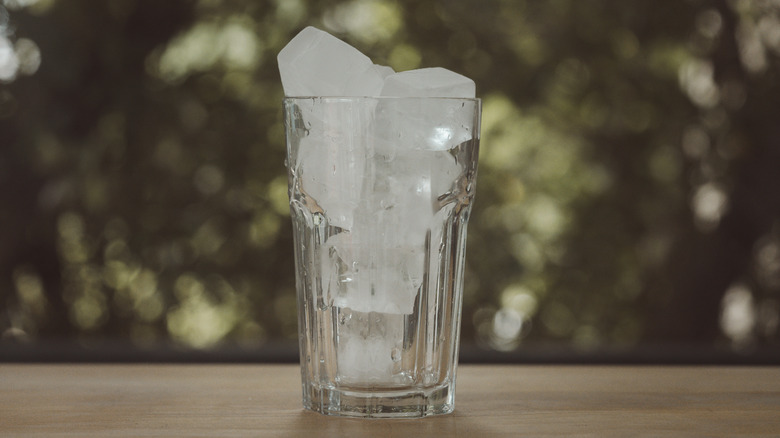 Glass filled with ice on outdoor table