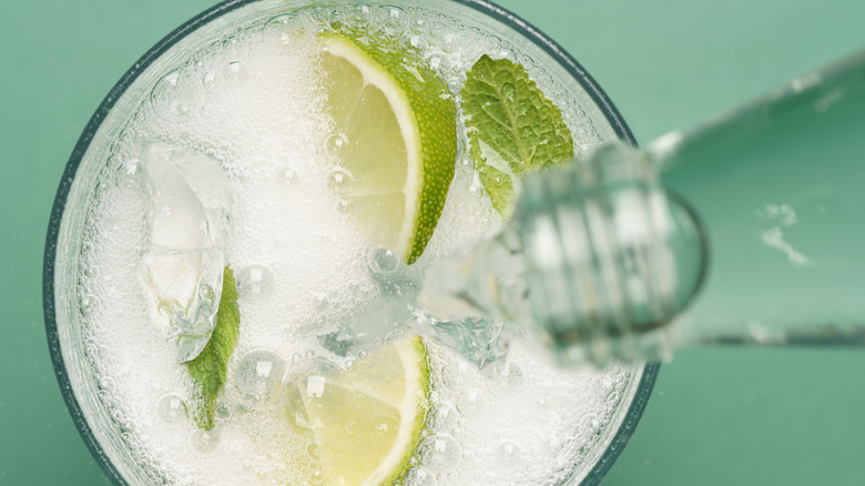 Topping up a drink with sparkling water