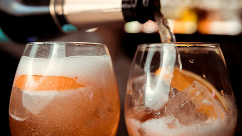 Sparkling wine being pouring into cocktails