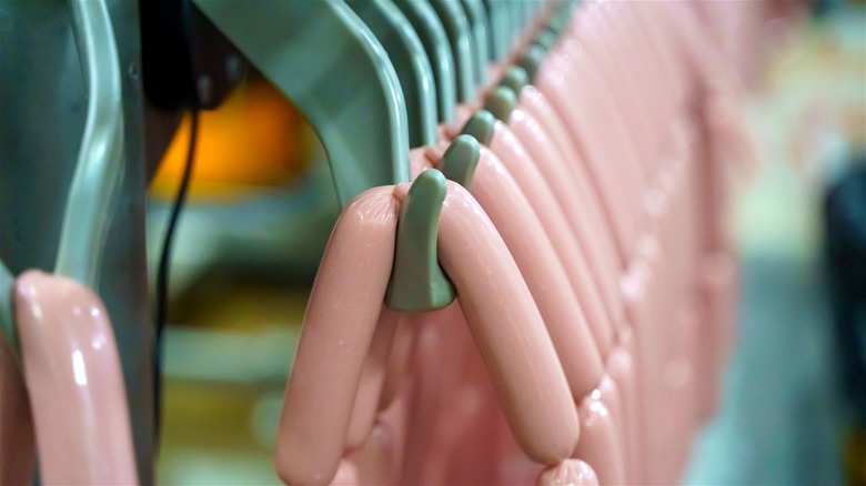 Hot dogs being processed in a factory.