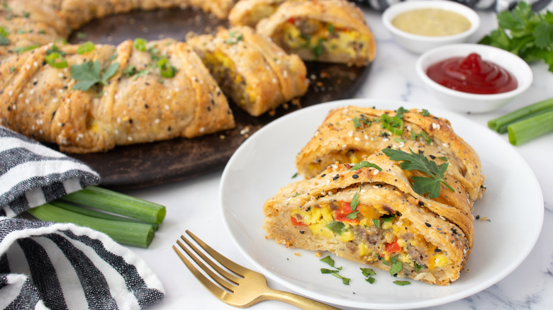 pastry filled with egg, sausage, and vegetables