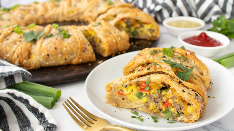pastry filled with egg, sausage, and vegetables