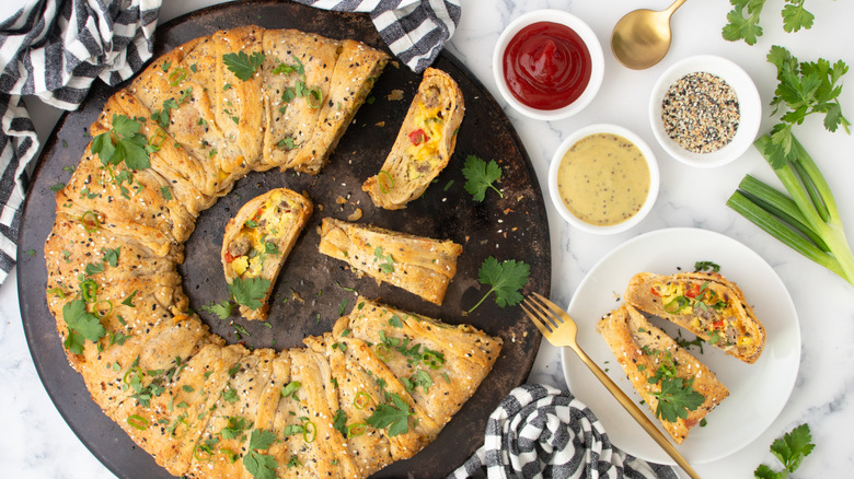 pastry filled with egg, sausage, and vegetables