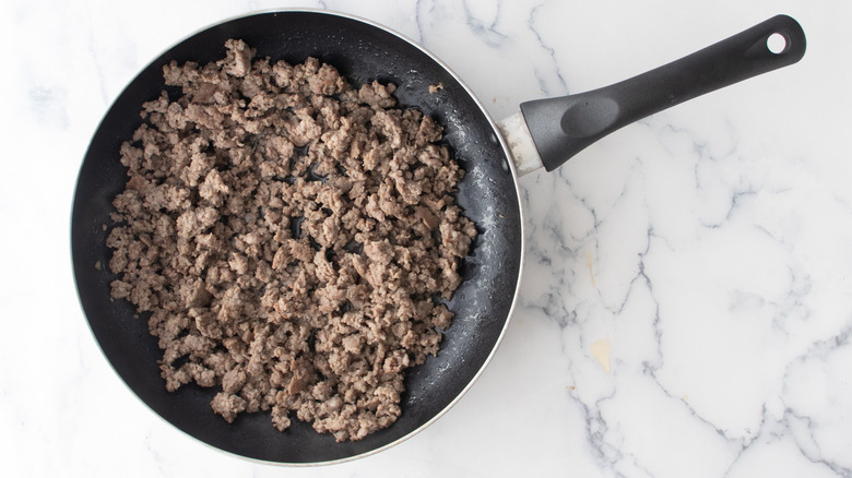 cooked sausage meat in a frying pan