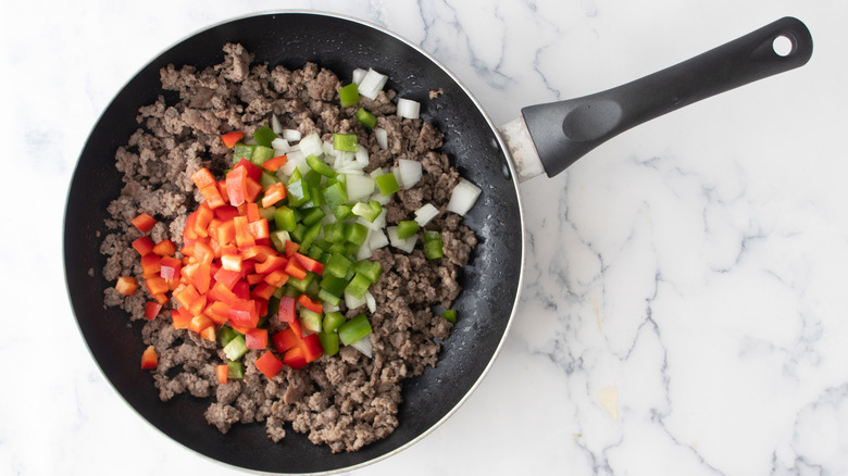 sausage, onions, and peppers in pan