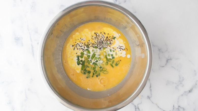 beaten eggs with seasonings in a bowl