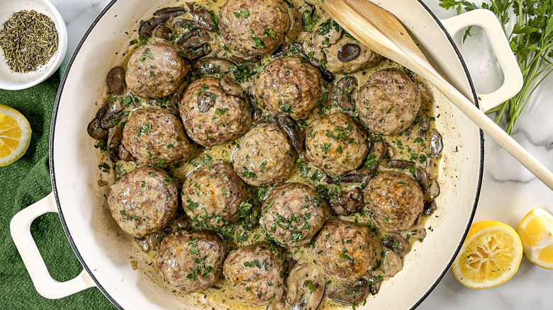 meatballs with herbs in a white pot