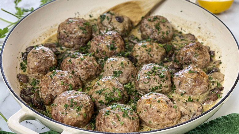 meatballs with herbs in a white pot