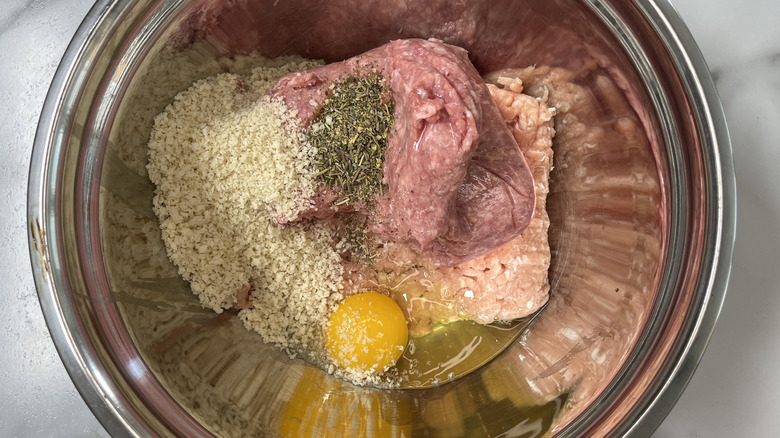 ground meat, seasonings, breadcrumbs, and egg in a metal bowl