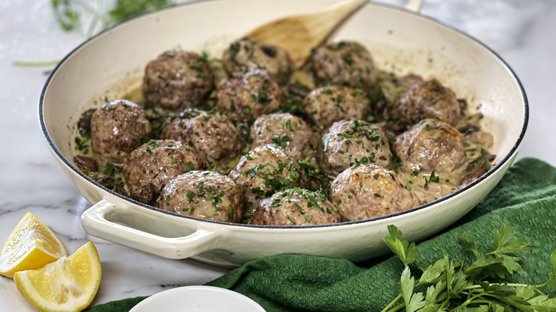 meatballs with herbs in a white pot