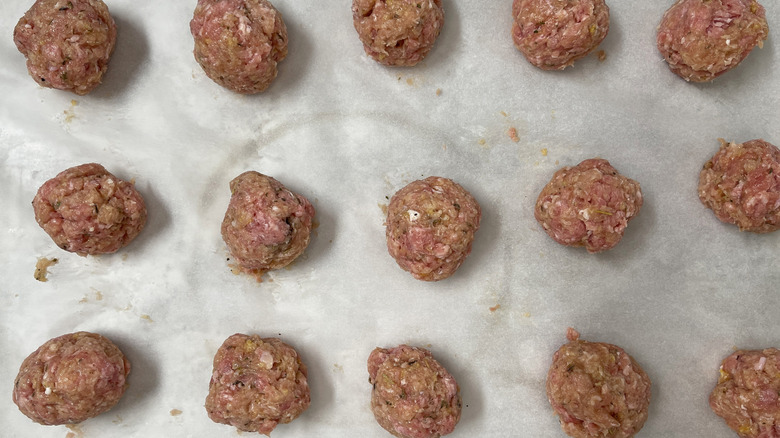 raw meatballs in a baking pan