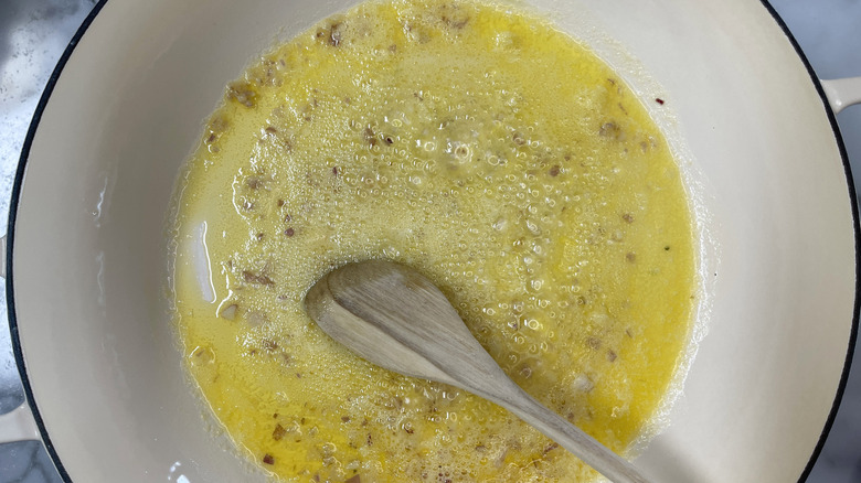 melted butter with aromatics in white pot