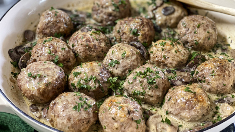 meatballs with herbs in a white pot