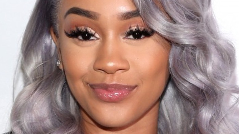 Saweetie with silver hair and slight smirk
