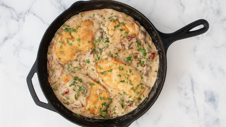 seared chicken with mushroom sauce in skillet