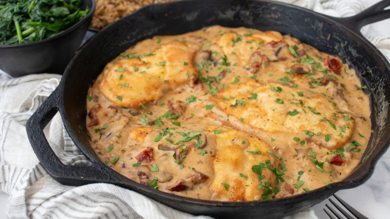 seared chicken with mushroom sauce in skillet