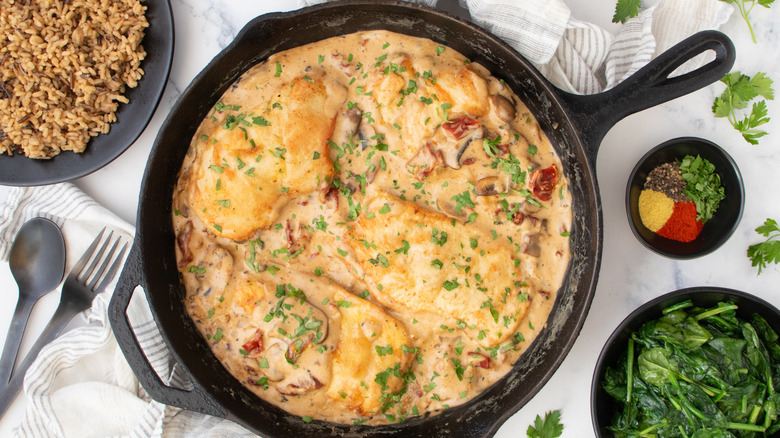 seared chicken with mushroom sauce in skillet