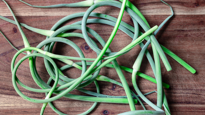 Garlic scapes on wooden board