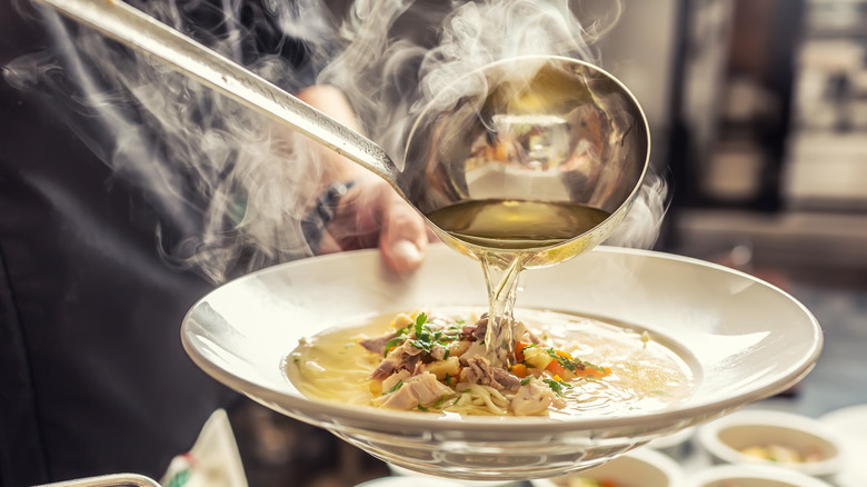 Pouring broth into a bowl