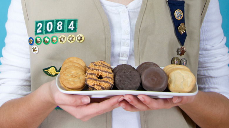 Girl Scout holding tray of cookies