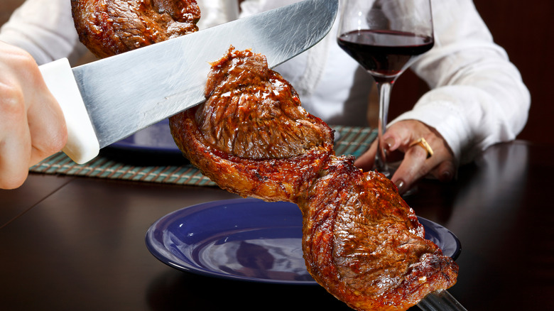 Meat being cut tableside at Brazilian steakhouse