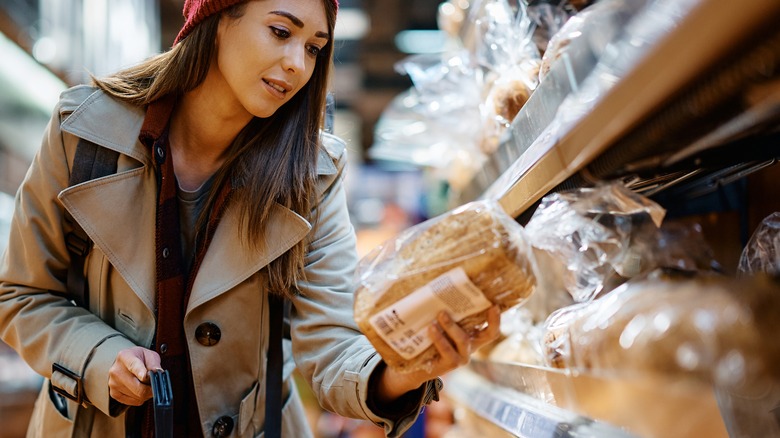 Woman buying bread in grocery store