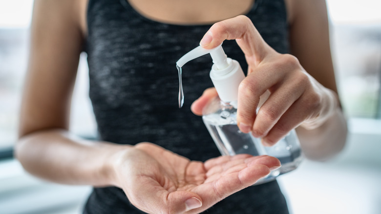 person using hand sanitizer