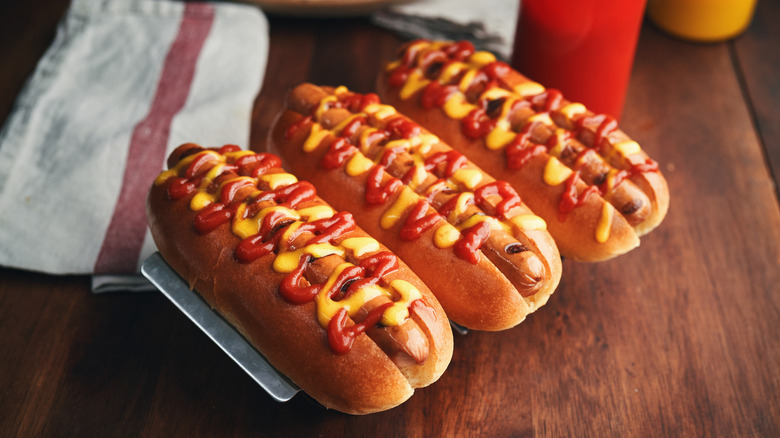 Hot dogs covered in mustard and ketchup 