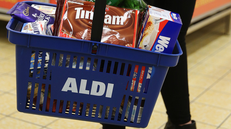 shopper holding Aldi basket