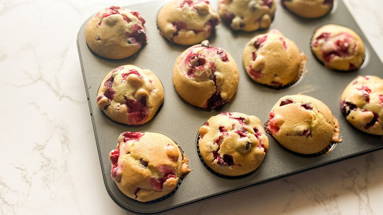 muffin tin with cranberry muffins