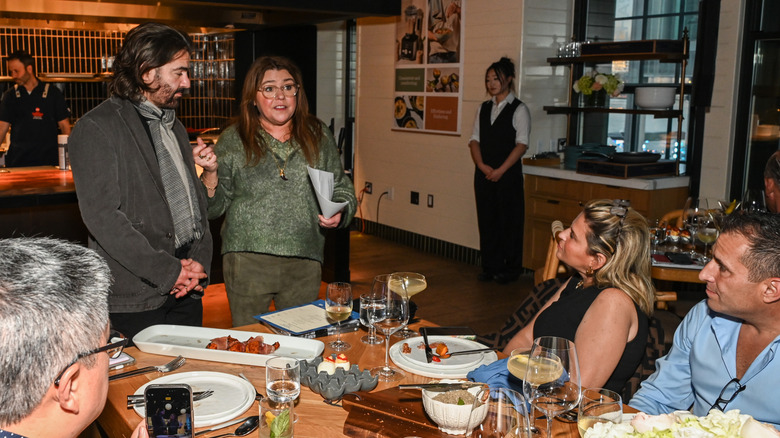 Rachael Ray and her husband John Cusimano speaking with guests at a Wine & Food Festival