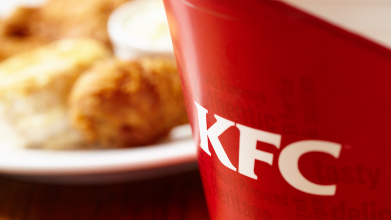 KFC bucket with chicken in background 