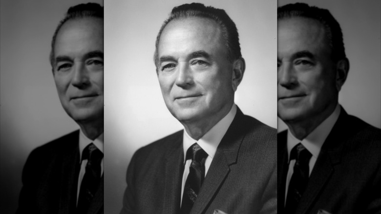 A black and white studio portrait of McDonald's owner Ray Kroc in a suit and tie