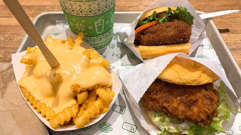 Shake Shack burgers on a tray with cheese fries