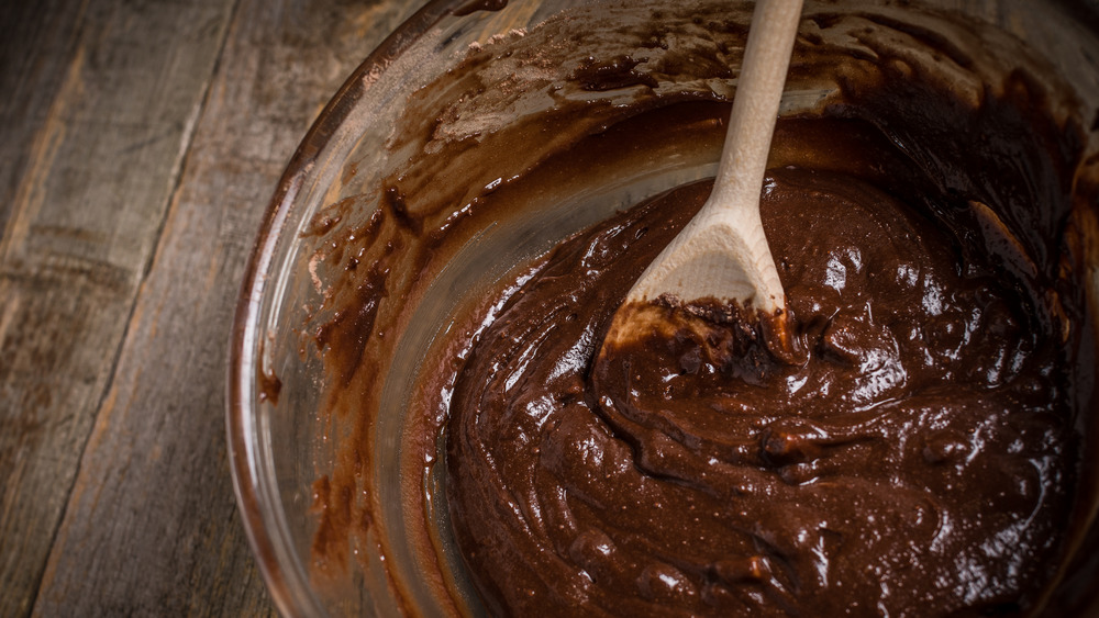 brownie batter being stirred in bowl