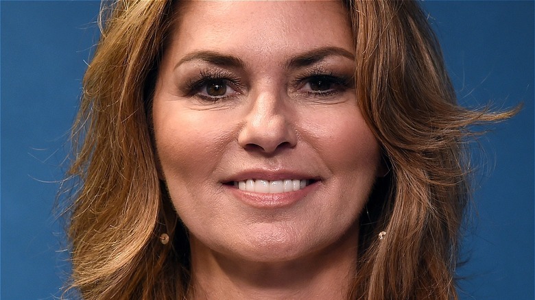 Shania Twain smiling with earrings