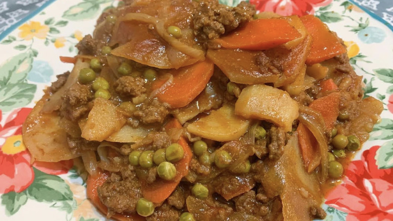 A plate of shipwreck casserole, a dish made of ground beef, beans, and vegetables.