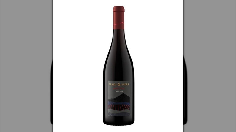 Bottle of Peaks & Tides pinot noir against white background.