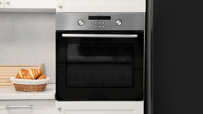 Black and chrome oven in white kitchen