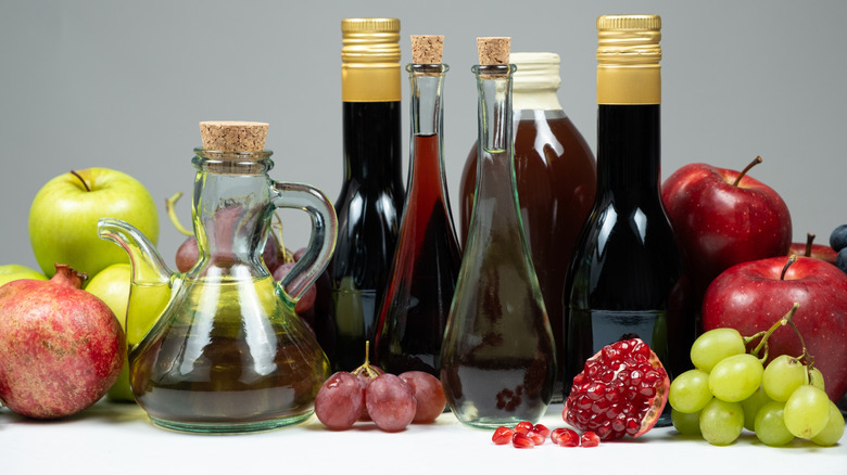 Different types of vinegars in glass bottles
