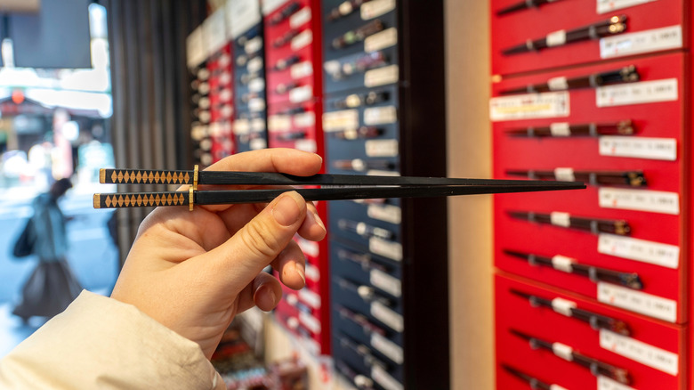 Person holding high-quality reusable chopsticks in store