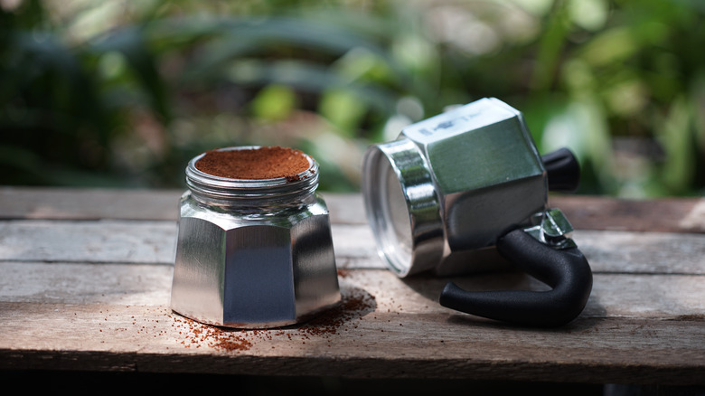 tamped coffee grounds in moka pot