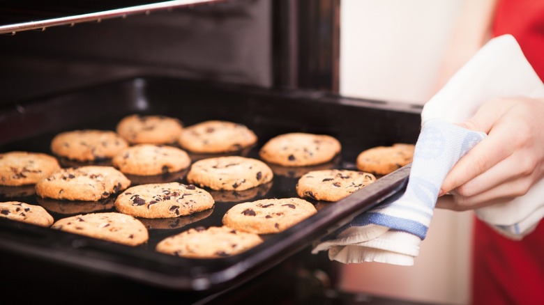 putting pan of cookies in oven