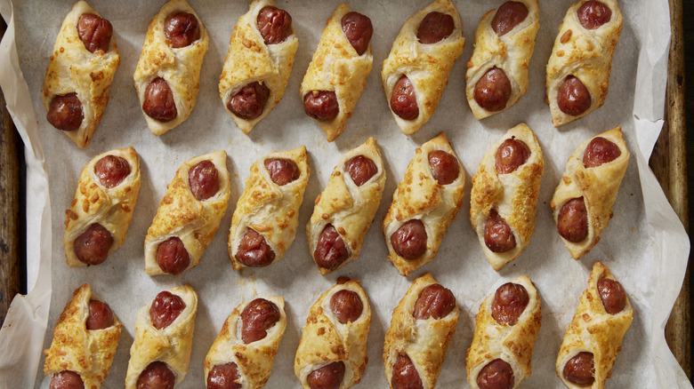 Pigs in a blanket on a layer of parchment paper