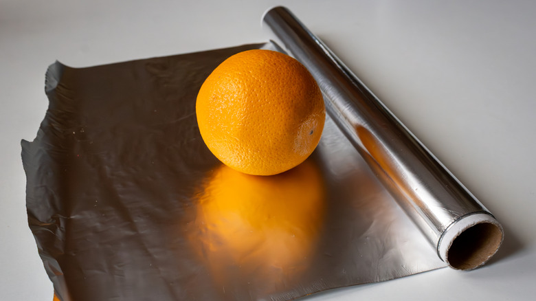 Orange on roll of aluminum foil